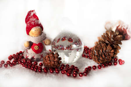 fir cone. toy snowman, snow and red beads all for the new yearの写真素材