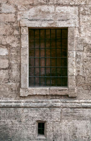 a small window in the historic stone building, close upの写真素材