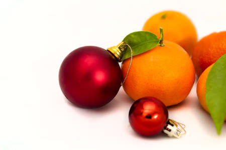 juicy mandarins and two red Christmas ballsの写真素材