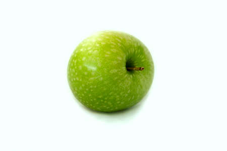 bright colorful mouthwatering green Apple on white backgroundの写真素材