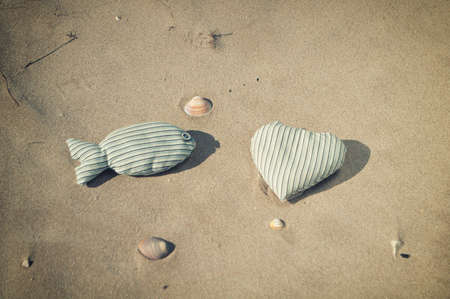figures from the fabric in the form of fish and heart on the beach
