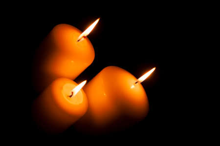 calm, bright, can be romantic or festive light candles on a black background. The light in the darkness.の写真素材