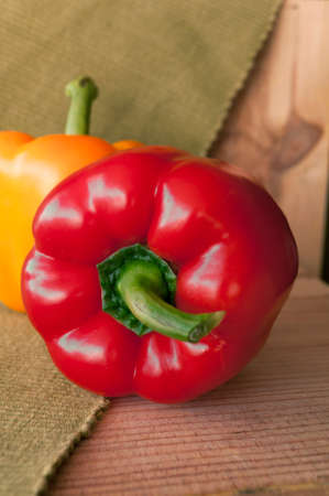 red and yellow Bulgarian pepper on the green tablecloth