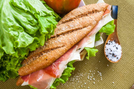 traditional Spanish sandwich with ham and cheese, delicious, fresh, diet, with lettuce bocadillo con jamon y quesoの写真素材