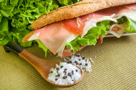 traditional Spanish sandwich with ham and cheese, delicious, fresh, diet, with lettuce bocadillo con jamon y quesoの写真素材