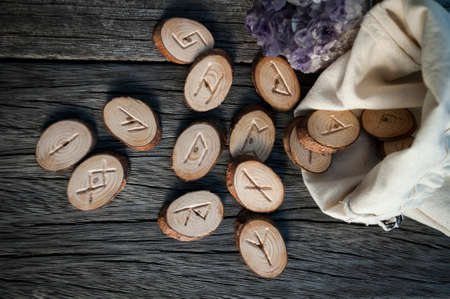 wood runes handmade on an old wooden table. Esoteric subjectsの写真素材
