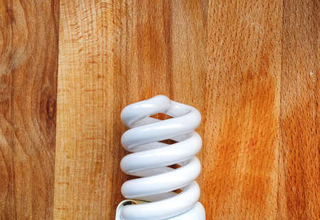 energy saving light bulb isolated on wood tableの写真素材
