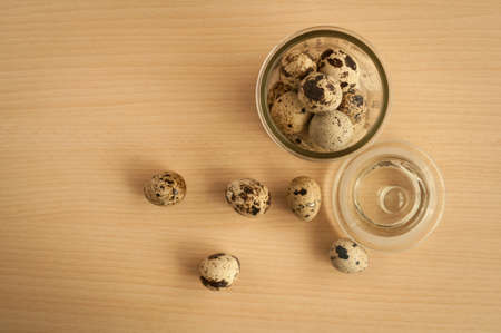 quail eggs in a decorative glass jar on the tableの写真素材