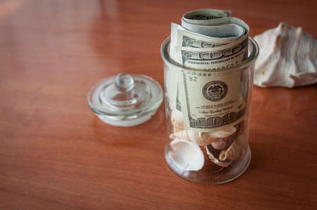 money in the jars on the table, savings for vacationの写真素材