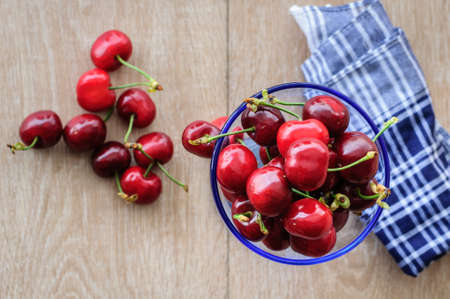 on the table in a glass container of ripe cherryの写真素材
