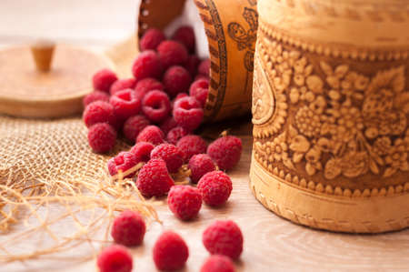 fresh, juicy raspberries scattered on the table from bast banksの写真素材