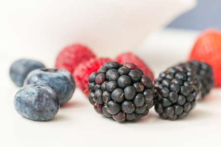 on a white background fresh, juicy wild berries blueberries raspberries strawberries and blackberries, delicious Supplement to any diet meals.の写真素材