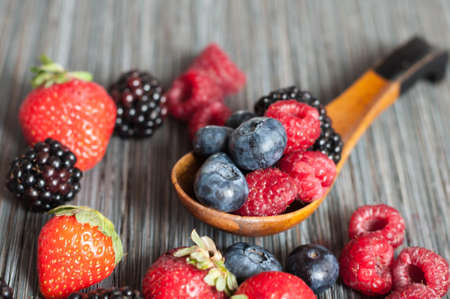 on a white background fresh, juicy wild berries blueberries raspberries strawberries and...