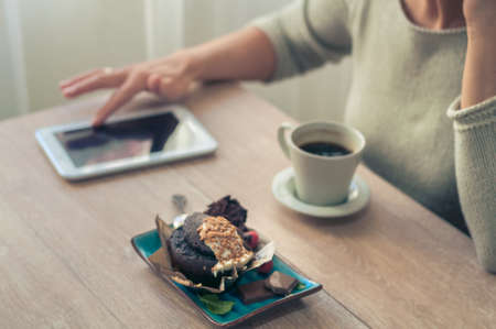 Delicious chocolate muffin with chocolate chips and fresh coffee for Breakfast best way to start the morning.の写真素材