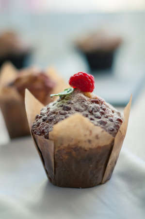 Black aromatic coffee with a fresh muffin and raspberries for Breakfastの写真素材