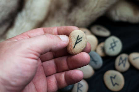 futark stone runes handmade on the handの写真素材
