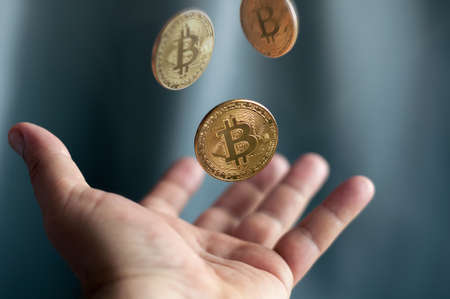 golden coins bitcoin falling into the hands