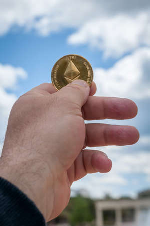 Ethereum coin in hand
