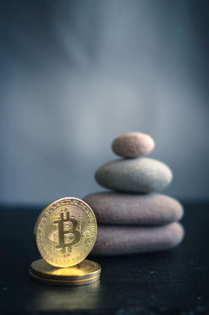Golden bitcoin coin on the background of the pyramid of stones is a symbol of stabilityの写真素材