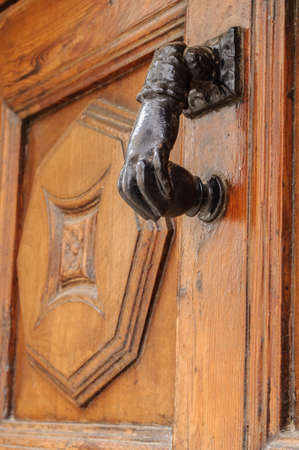 ancient iron door knocker on medieval houseの写真素材