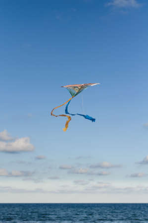 air paper colorful kite in the sky over the seaの写真素材