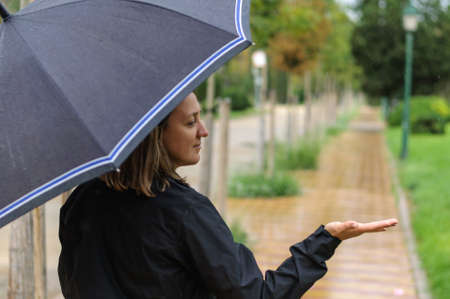 girl in the city in the rain with an umbrella