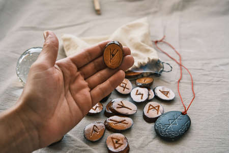 in the girls hand are wooden runesの写真素材