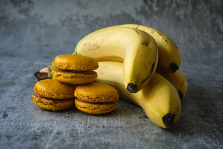 yellow macaroni cookies on a gray background with a bananaの写真素材