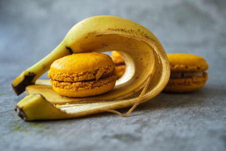yellow macaroni cookies on a gray background with a bananaの写真素材