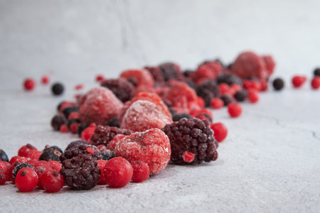 red berries scattered on a white backgroundの写真素材