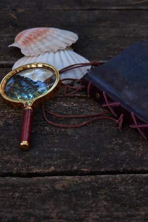 on the wooden table is a leather-bound notebookの写真素材