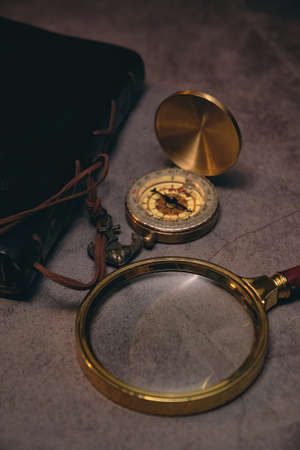 compass, book, and magnifying glassの写真素材