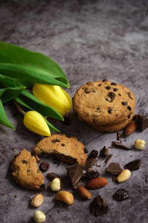 chocolate cookies and tulips on a gray backgroundの写真素材