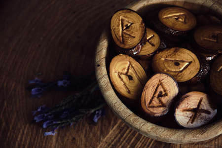 homemade wooden runes on a dark background