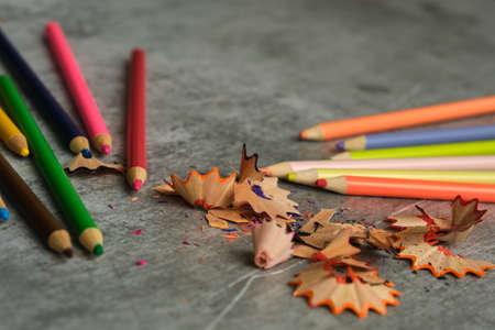bright colored pencils on a gray background