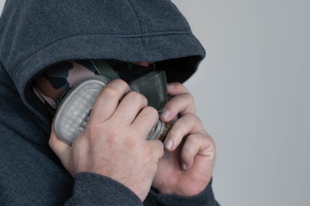 a man in a respiratory mask in a jacket with a hoodのeditorial素材
