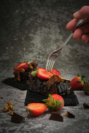two chocolate cake with strawberries on a gray backgroundの写真素材