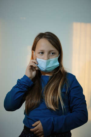 a girl posing with medical mask on the face