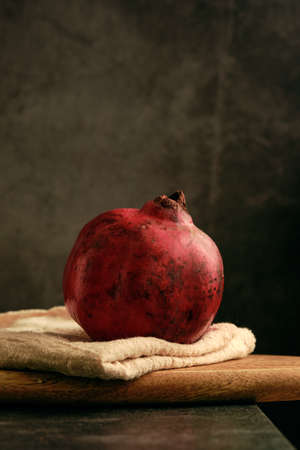 ripe pomegranate on the tableの写真素材