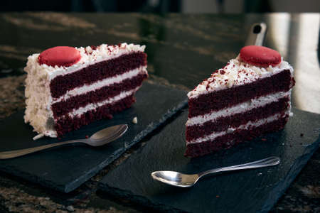 two pieces of red velvet cake with cookies on top
