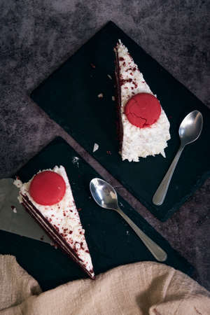 two pieces of red velvet cake with cookies on top