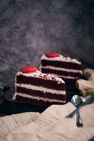 two pieces of red velvet cake with cookies on top