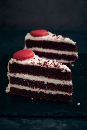 two pieces of red velvet cake with cookies on top