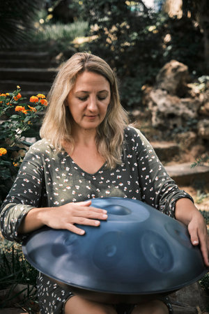 a woman plays on handpan or hang