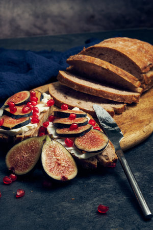 slices of rye bread with figs and pomegranateの写真素材