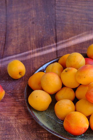 yellow ripe apricots on a plateの写真素材