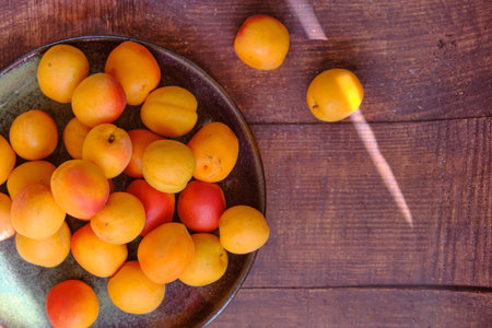 yellow ripe apricots on a plateの写真素材