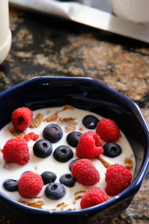 Cereal with milk and berries for breakfast