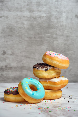 a stack of donuts of various shapes and colorsの写真素材