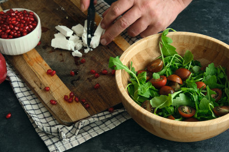 green fresh diet salad of arugula tomatoes cheese and pomegranate